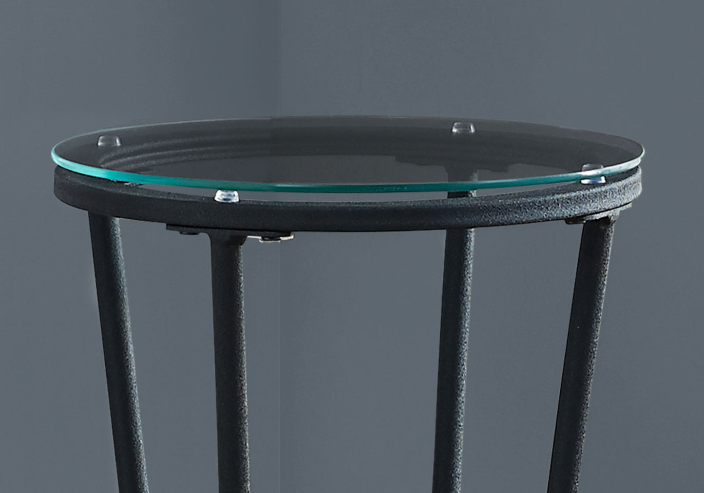 Round glass top accent table with black metal base and legs