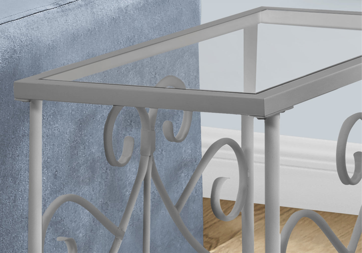Grey metal and glass console table with ornate scrolled legs perfect for entryways