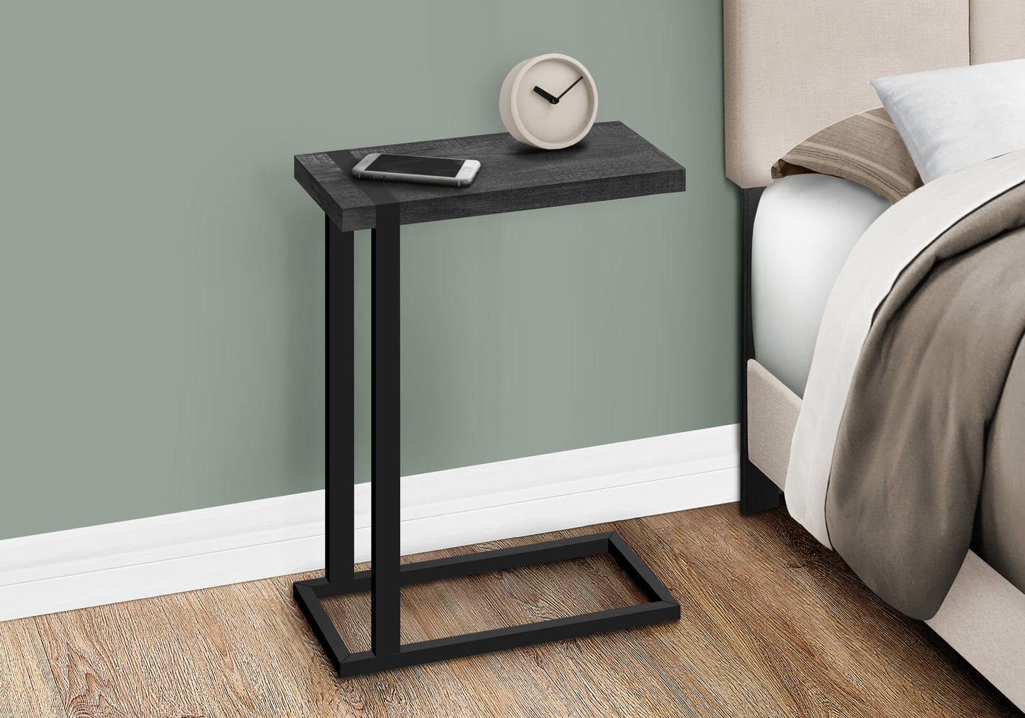 Dark gray wood Ctable with black metal frame holding a phone and clock