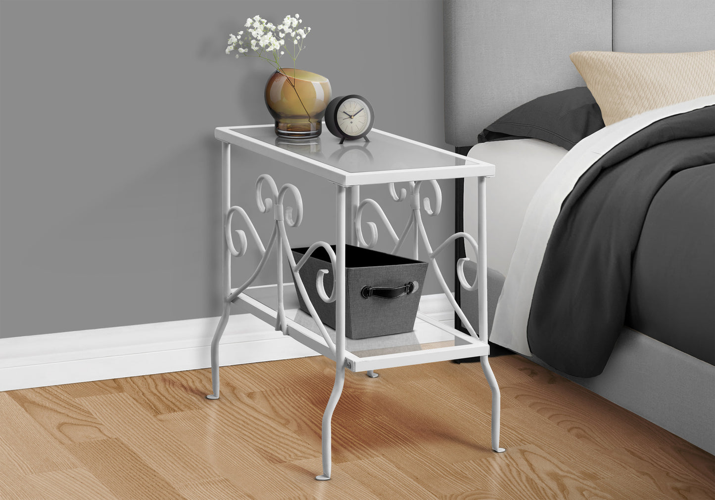 White metal accent table with glass top and decorative scrollwork