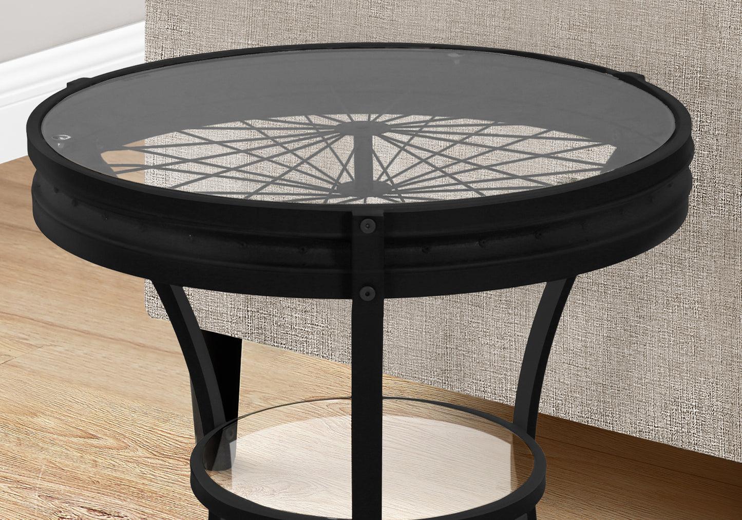 Round black metal coffee table with glass top and wheelspoke design