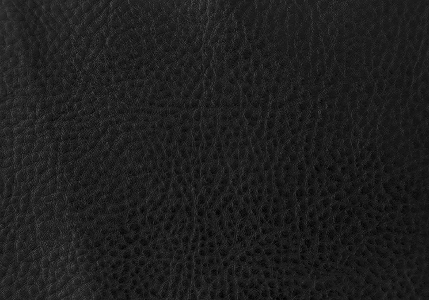 Closeup of textured black leather material for bags and upholstery