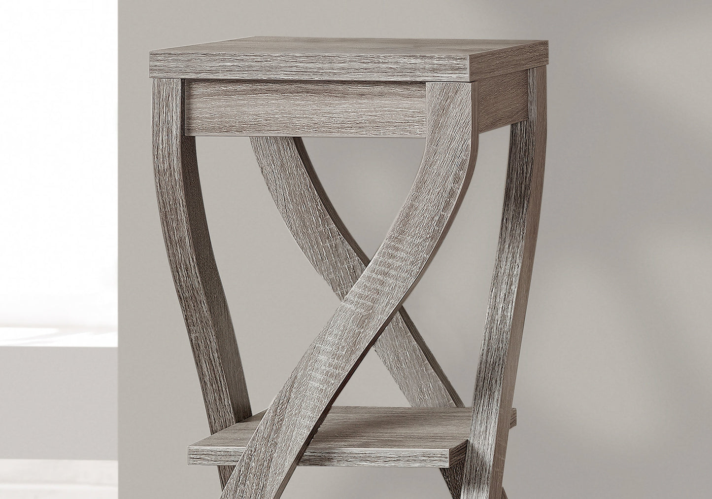 Gray wood accent table with intersecting legs and a lower shelf perfect for small spaces