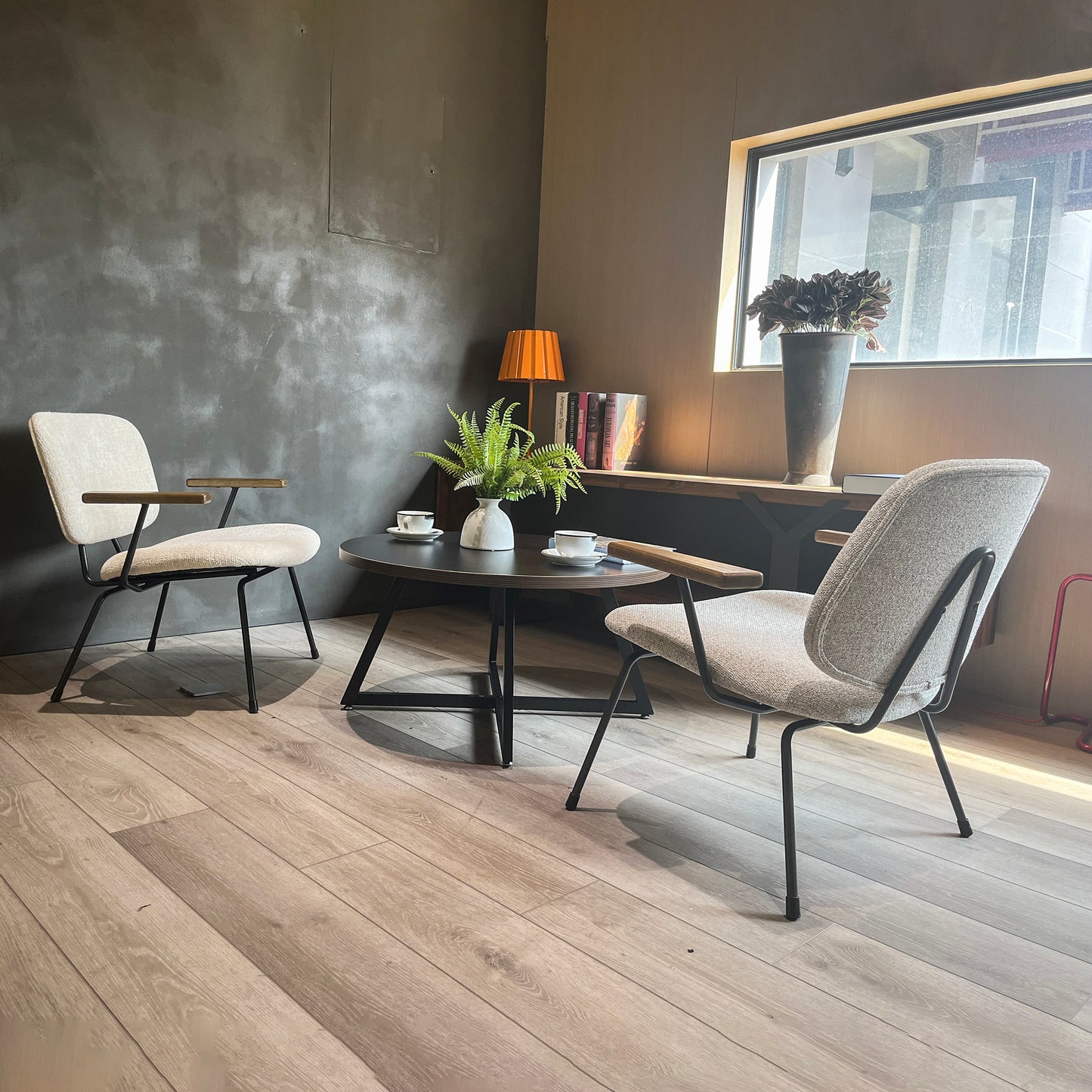 Textured beige fabric armchair with black metal legs and wooden armrests