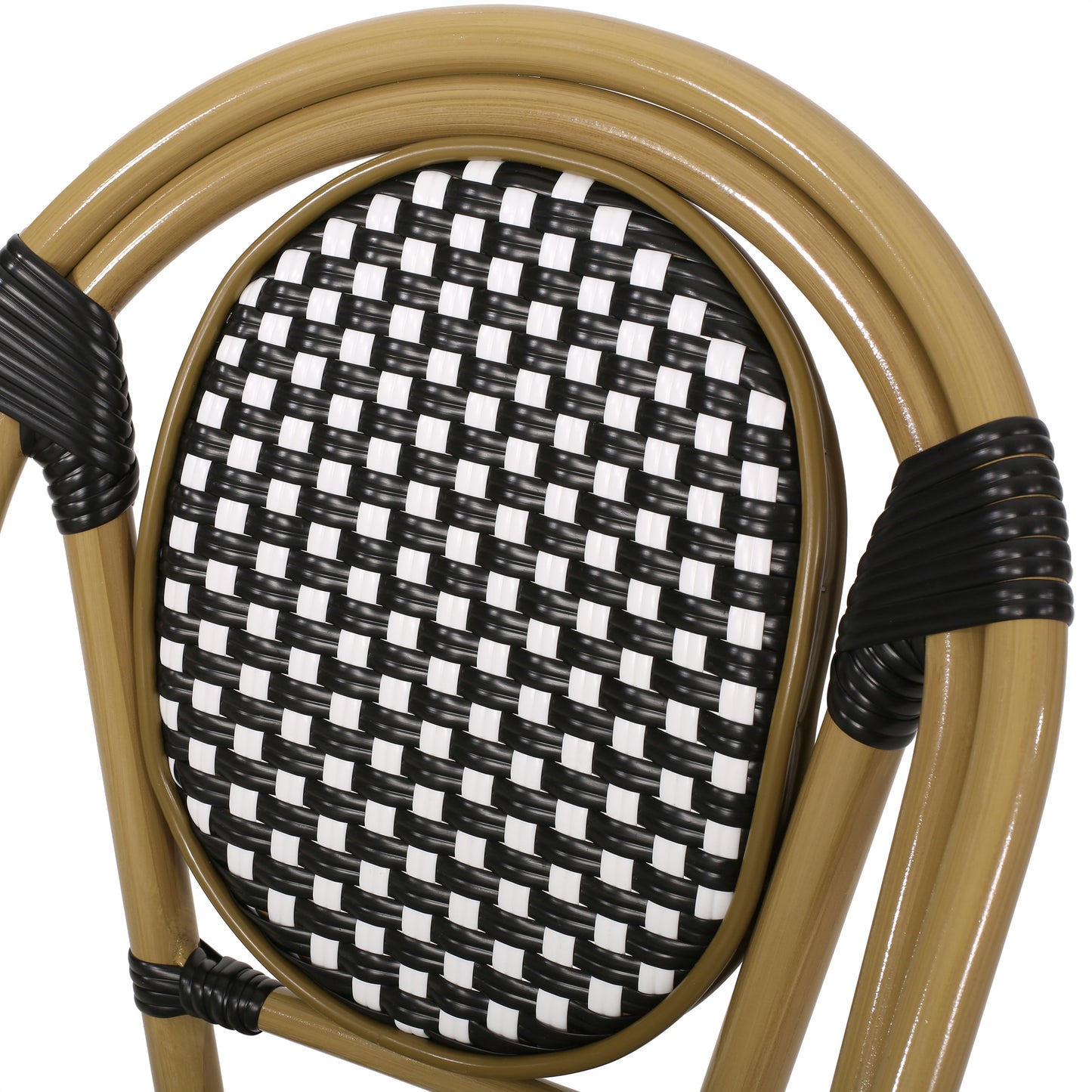 Closeup of a woven rattan cafe chair with black and white seat pattern
