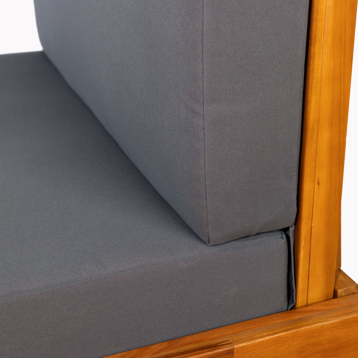 Closeup of grey outdoor furniture cushion with natural wood frame