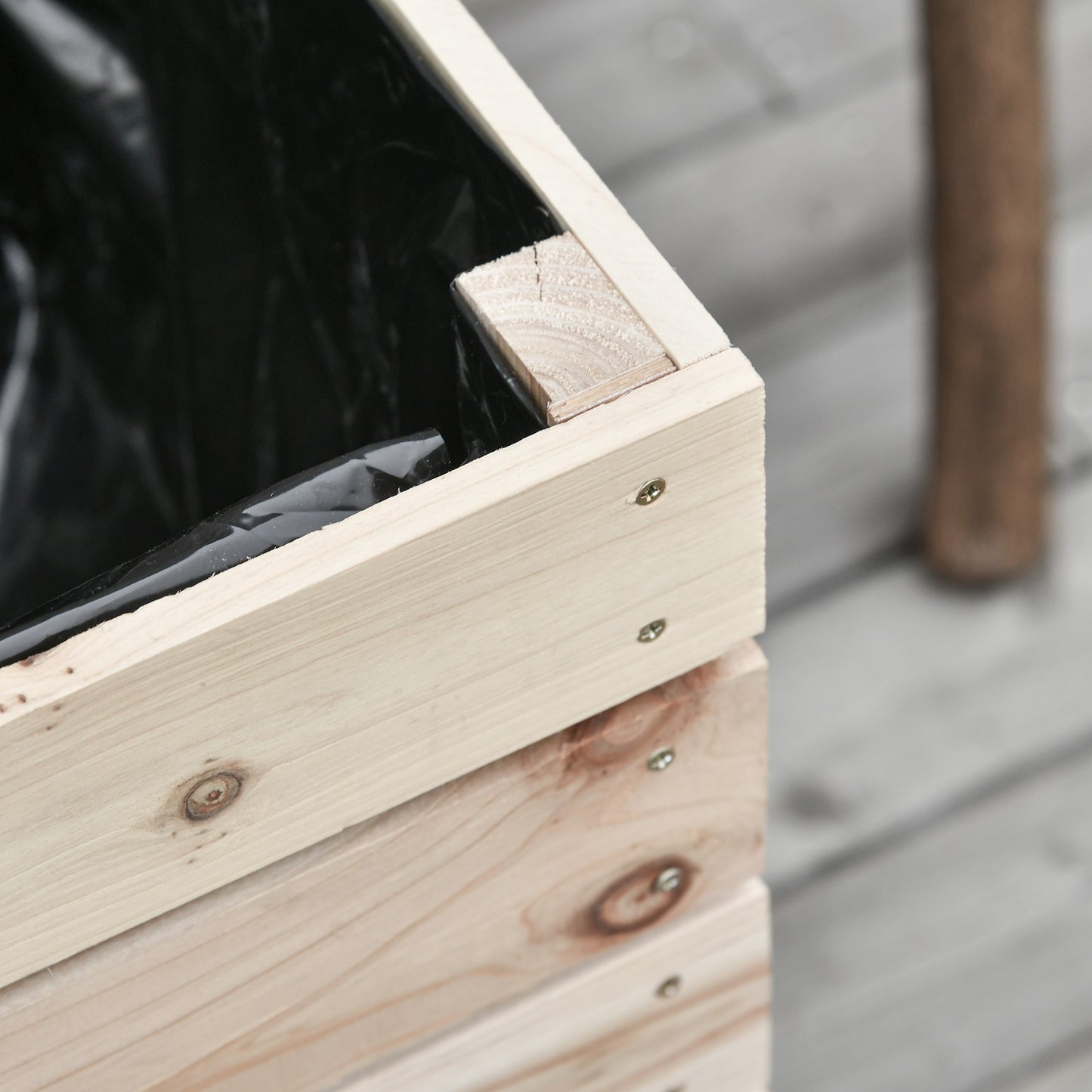Unfinished pine planter box with black liner and visible screw details