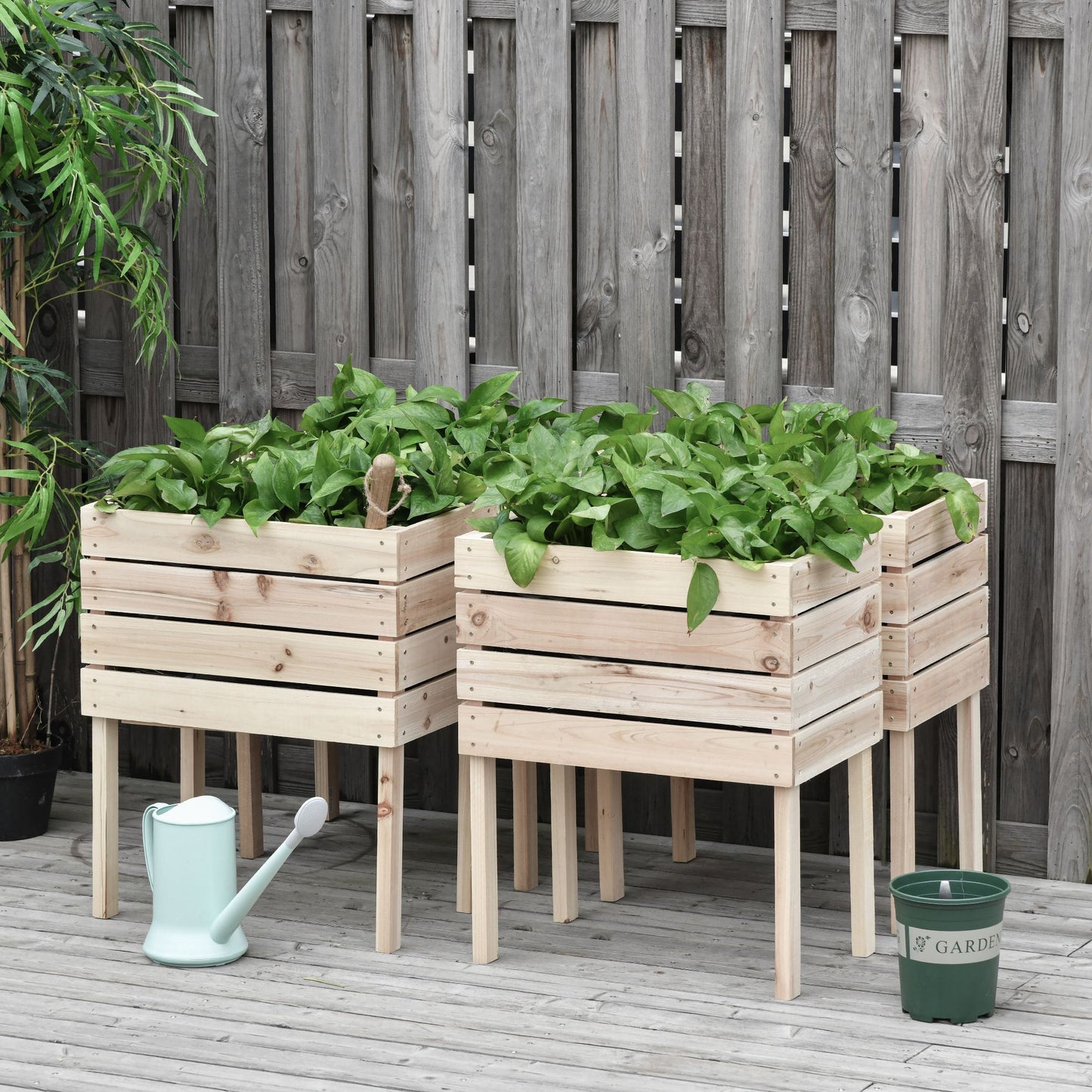 Natural wood elevated garden bed with lush green plants