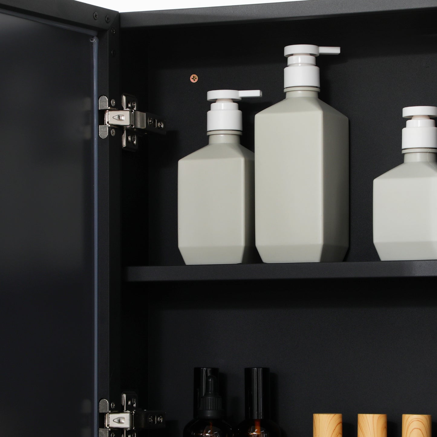 Gray pump bottles for shampoo and conditioner with white pump dispensers neatly arranged on a shelf