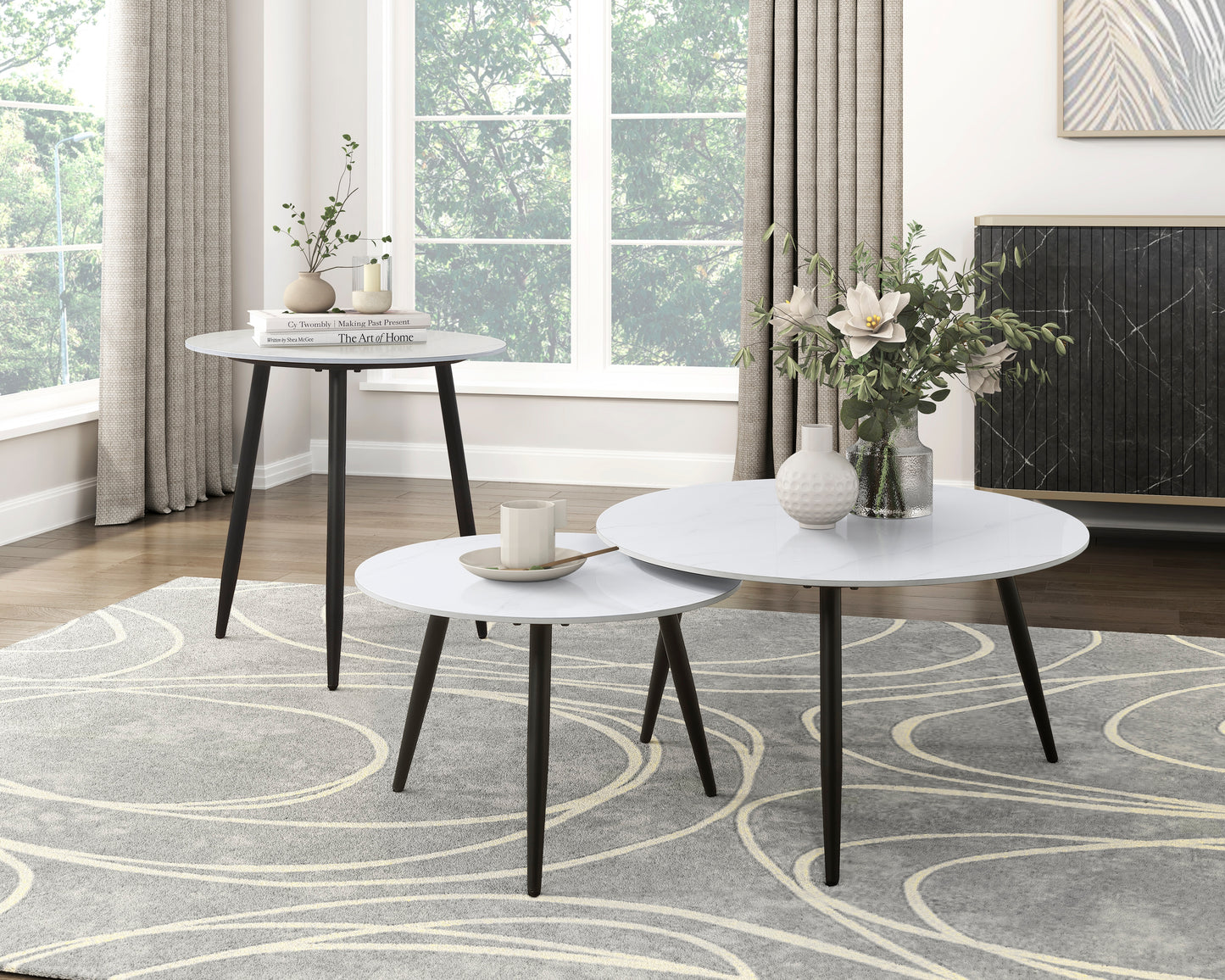 White marblelook round coffee table set with black tapered legs
