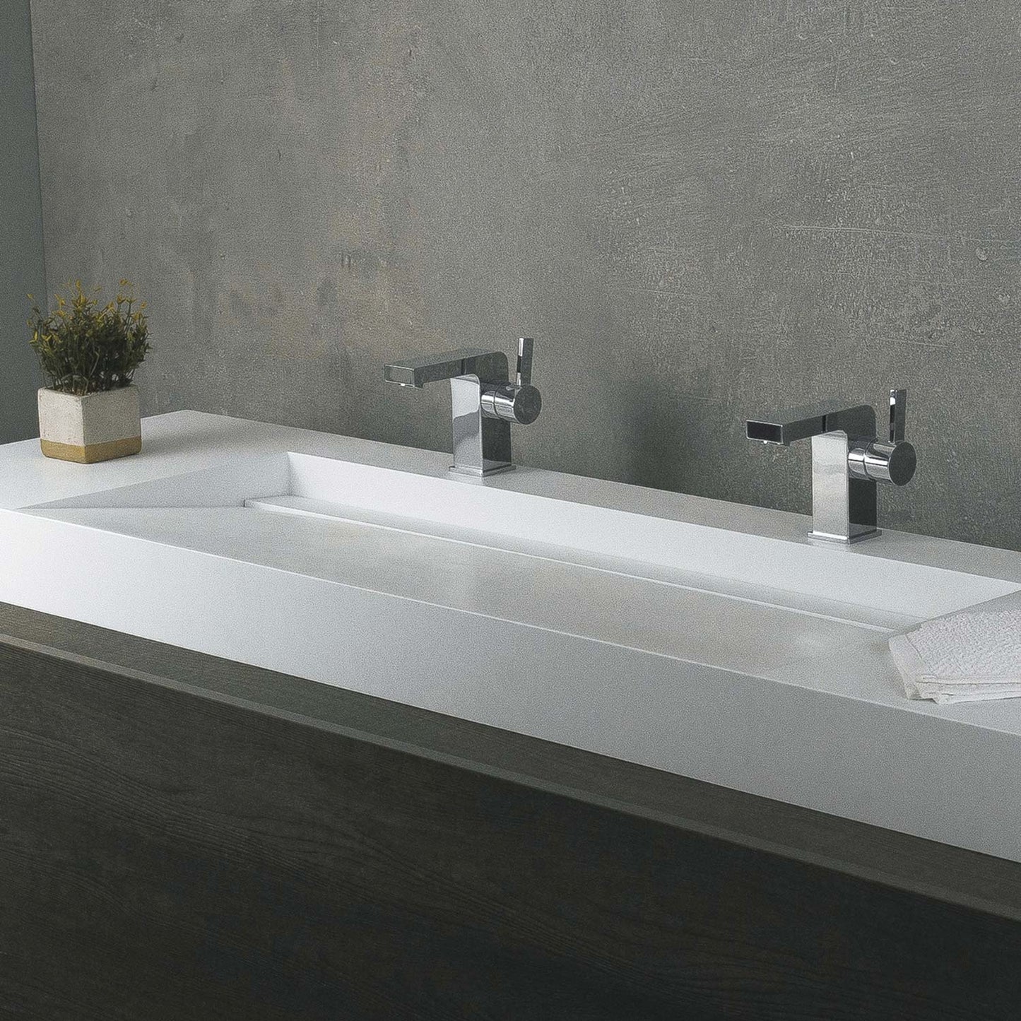Modern white double basin sink with polished chrome faucets and concrete wall
