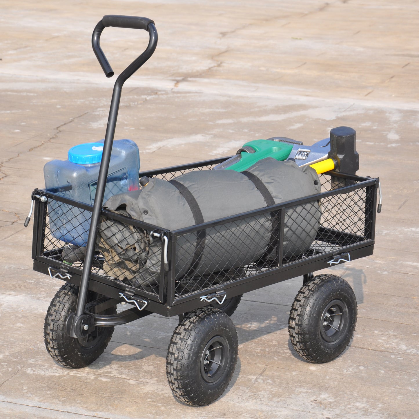 Heavyduty garden cart with large wheels and mesh bed loaded with camping gear and water jugs