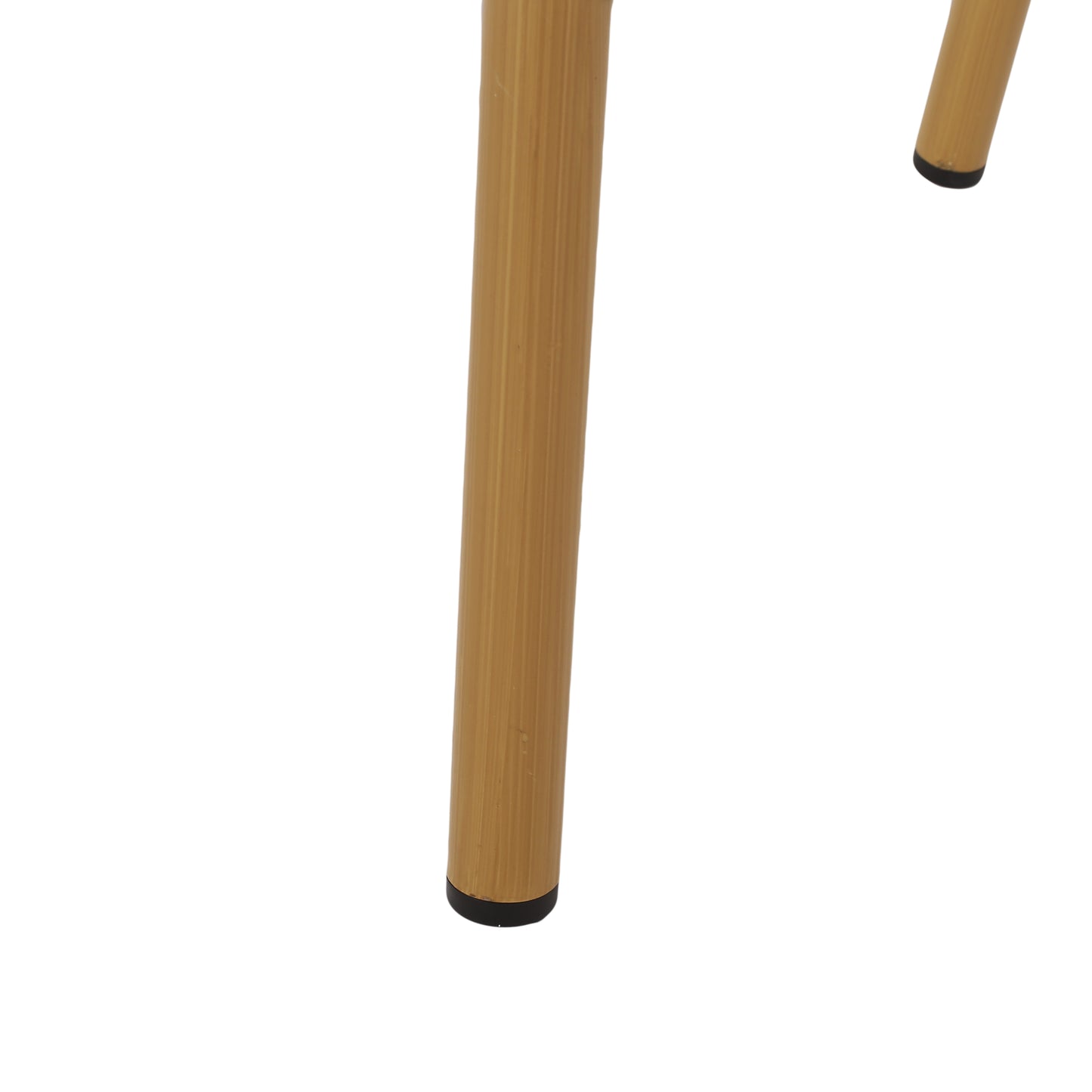 Detail of ribbed brass metal table legs with black feet