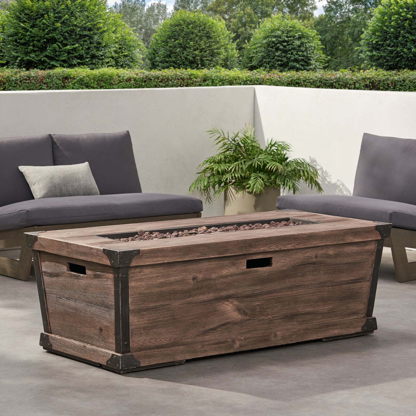 Rustic brown wood patio fire pit table with metal accents and lava rocks