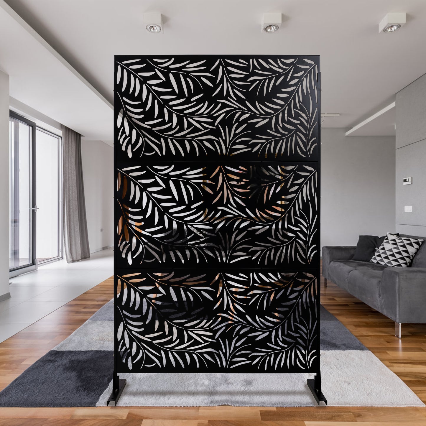 Black metal room divider screen with a white palm leaf cutout design
