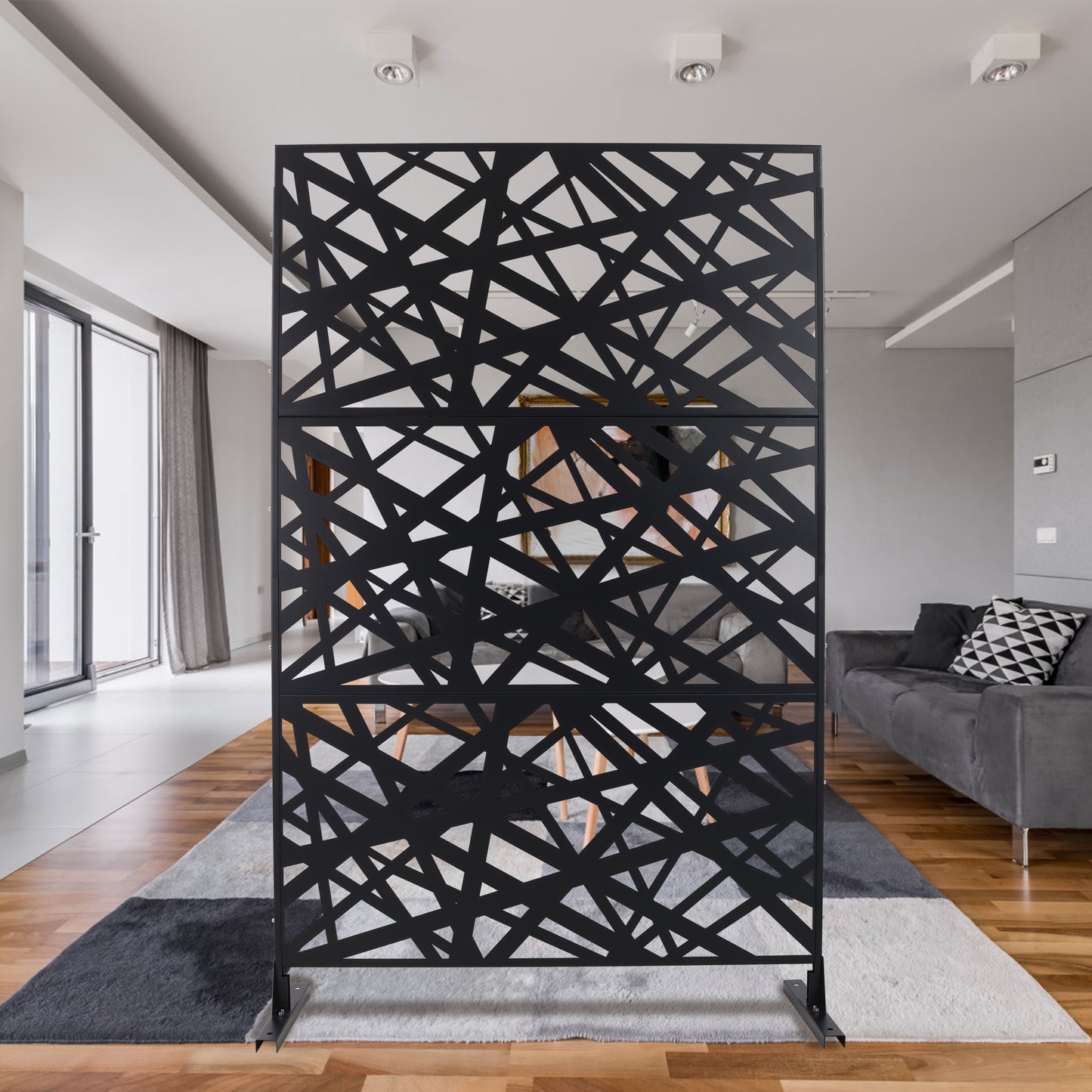 Black metal room divider with abstract geometric cutout pattern modern design