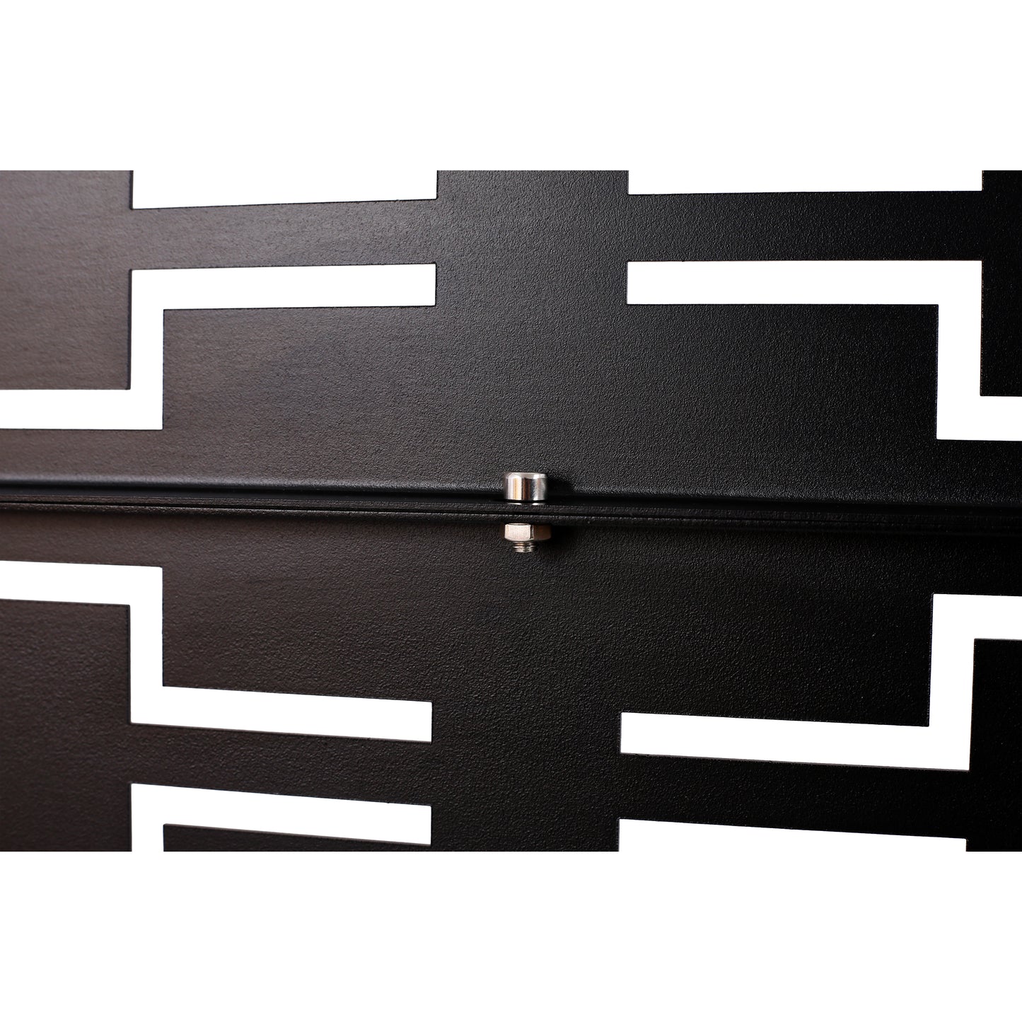 Closeup of textured black metal with a white geometric cutout pattern featuring a silver bolt