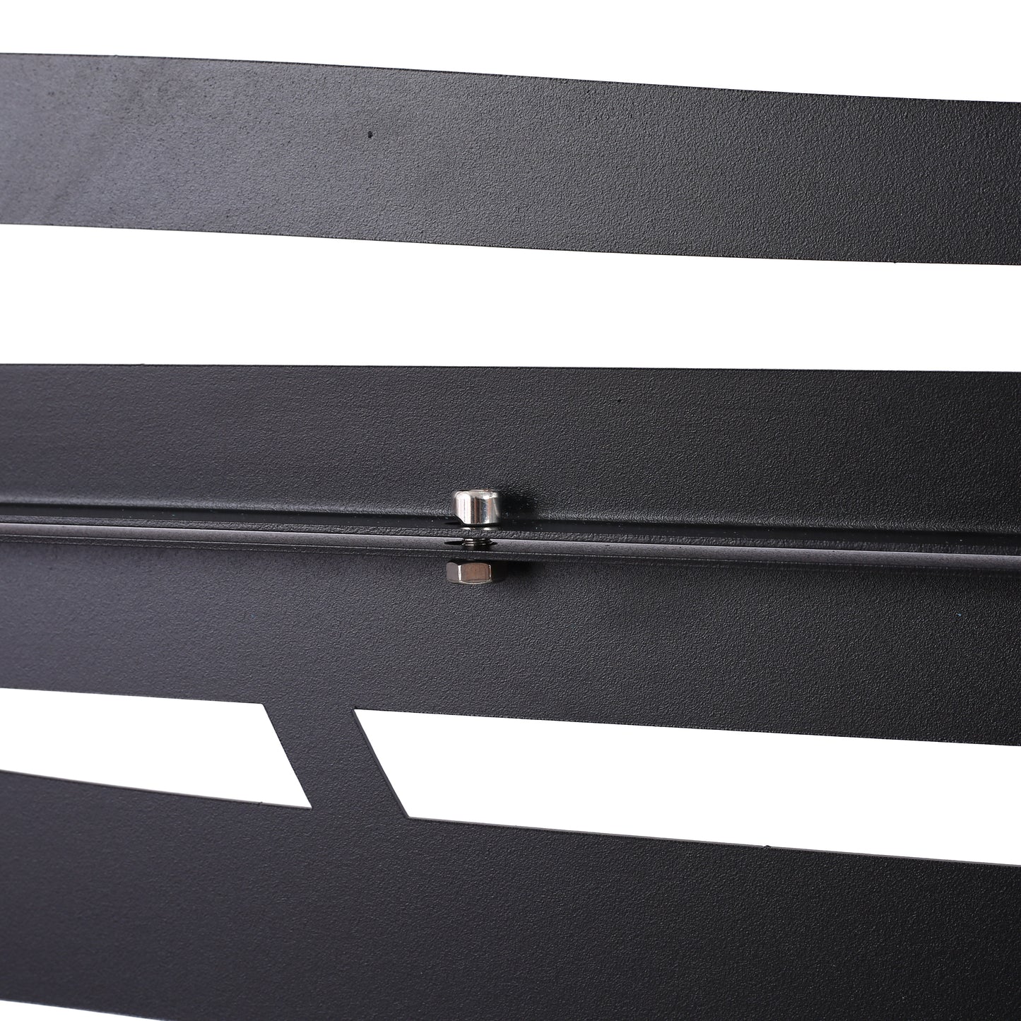 Textured black metal panel with geometric cutouts and silver bolt detail