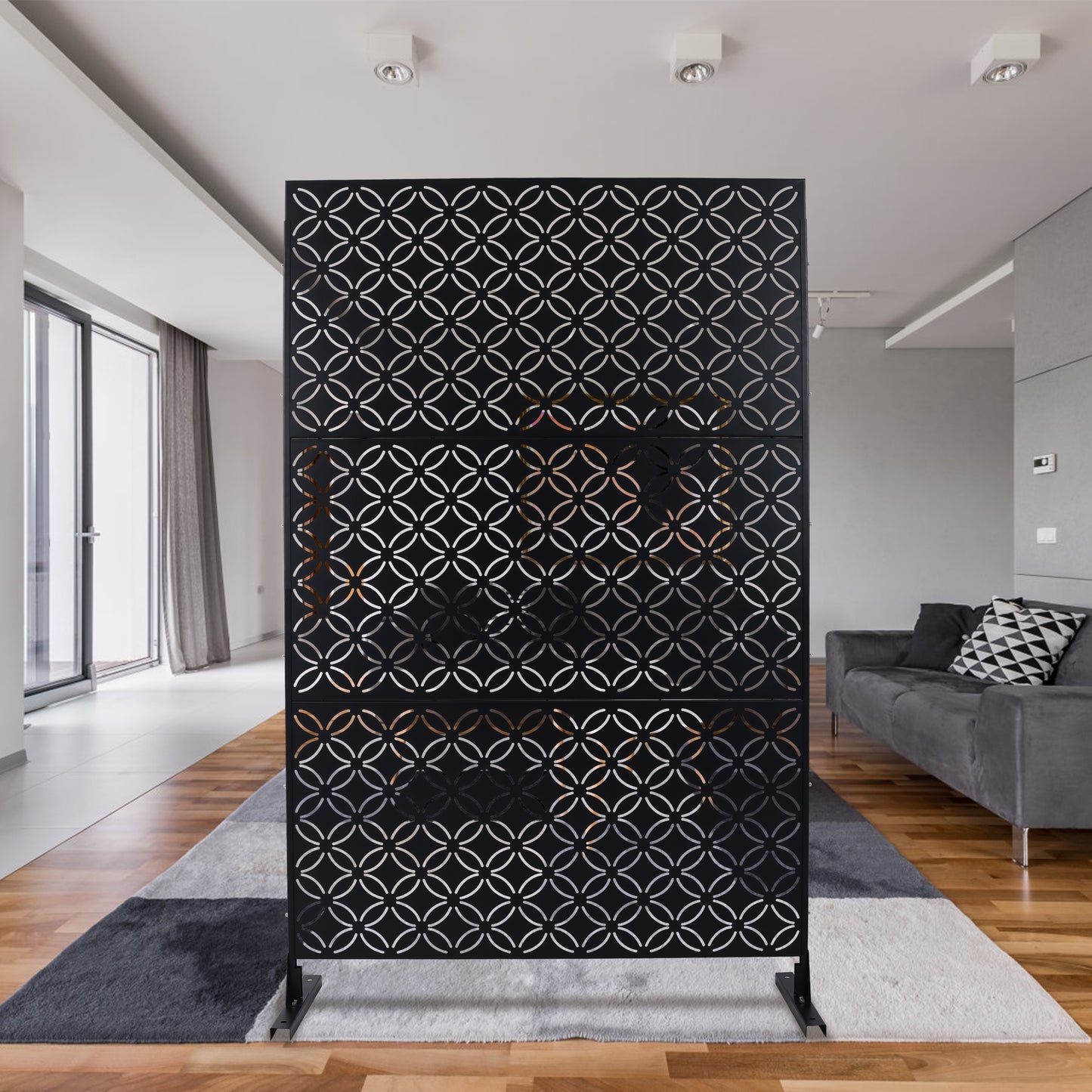 Black metal room divider with interlocking circle geometric pattern