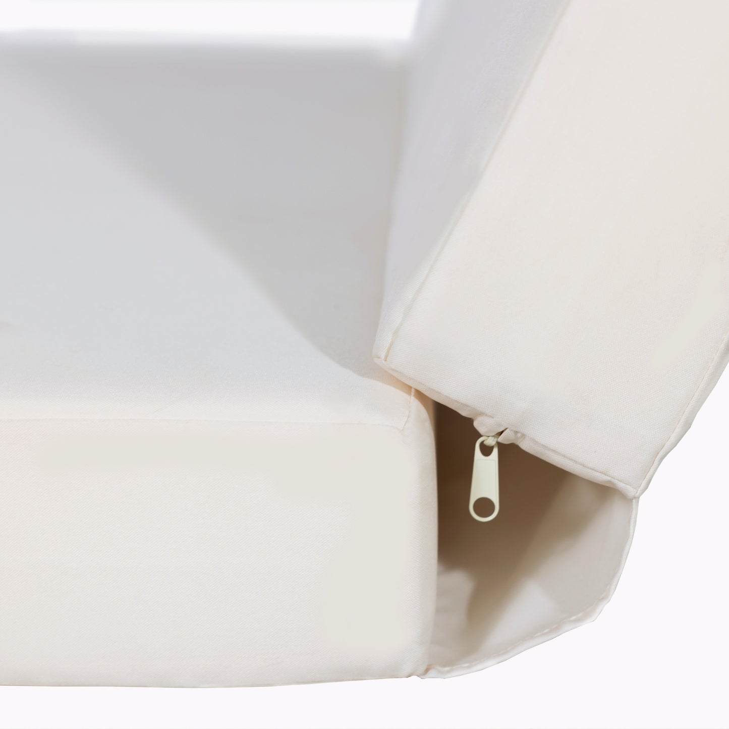 Closeup of a textured cream sofa cushion with a visible zipper detail for easy cleaning