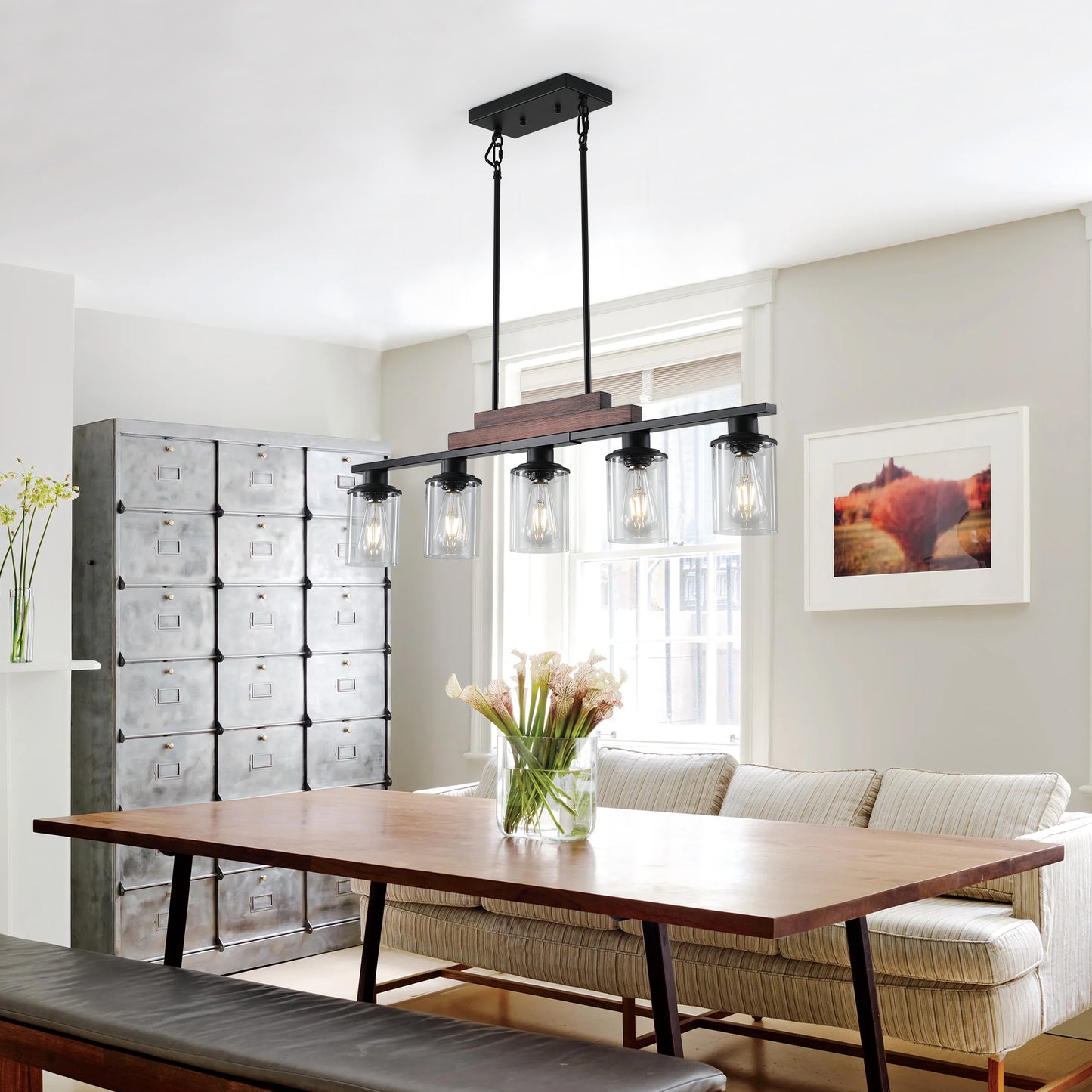 Modern black linear chandelier with four glass pendant lights and a wood accent piece