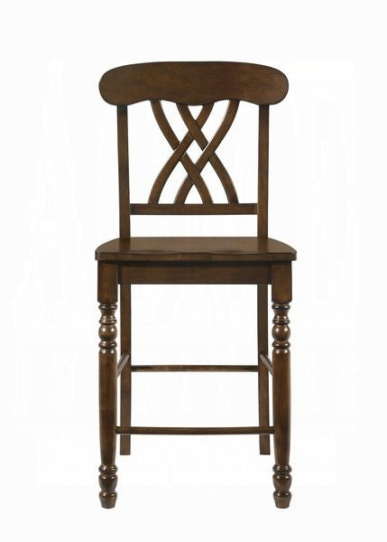 Dark brown wooden bar stool with an ornate crossback design and turned legs