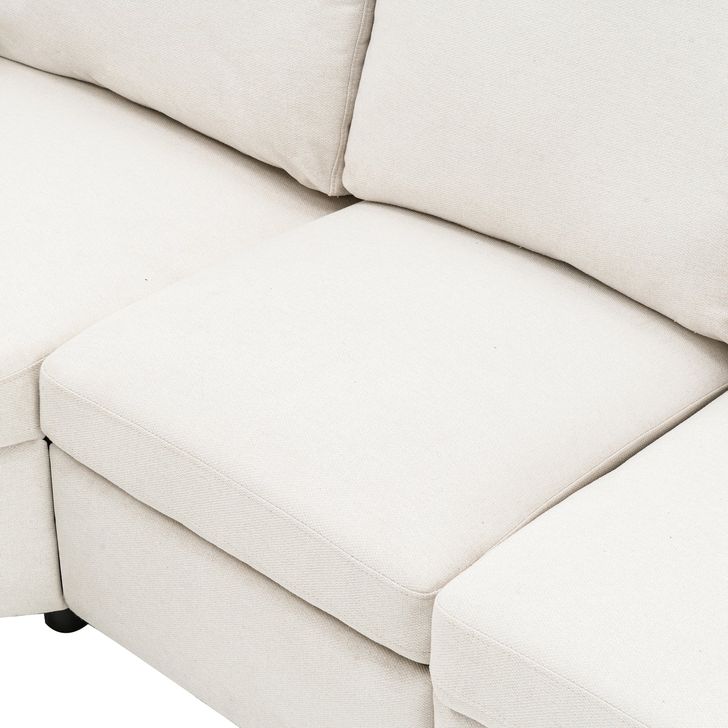Closeup of a textured cream fabric sofa seat and back cushions showing plush comfort