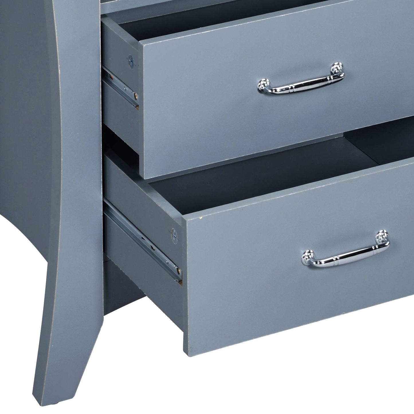 Closeup of grey wooden dresser drawers with polished chrome handles