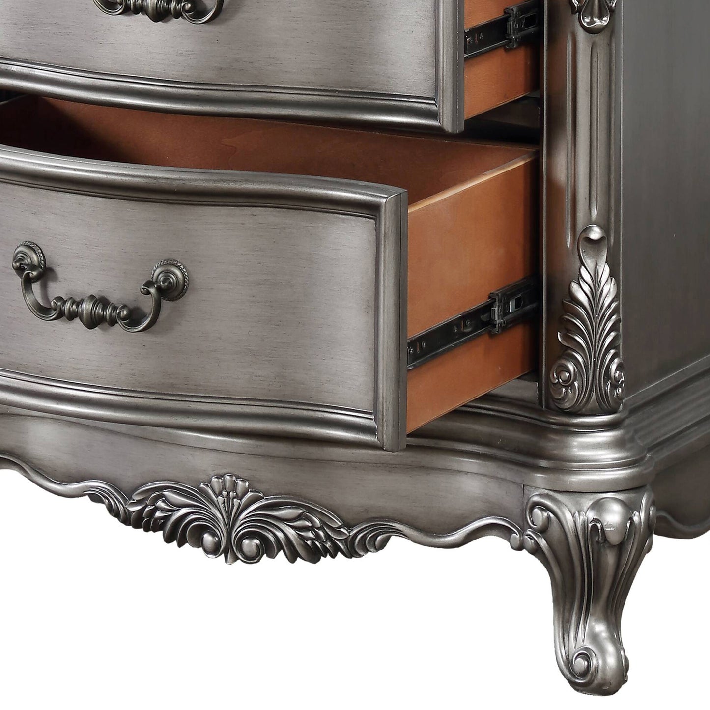 Ornate antique silver dresser with carved details and dark wood drawers