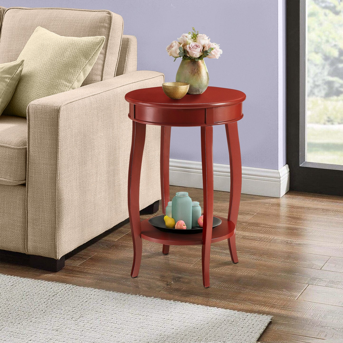 Round red end table with decorative vases and faux fruit on bottom shelf