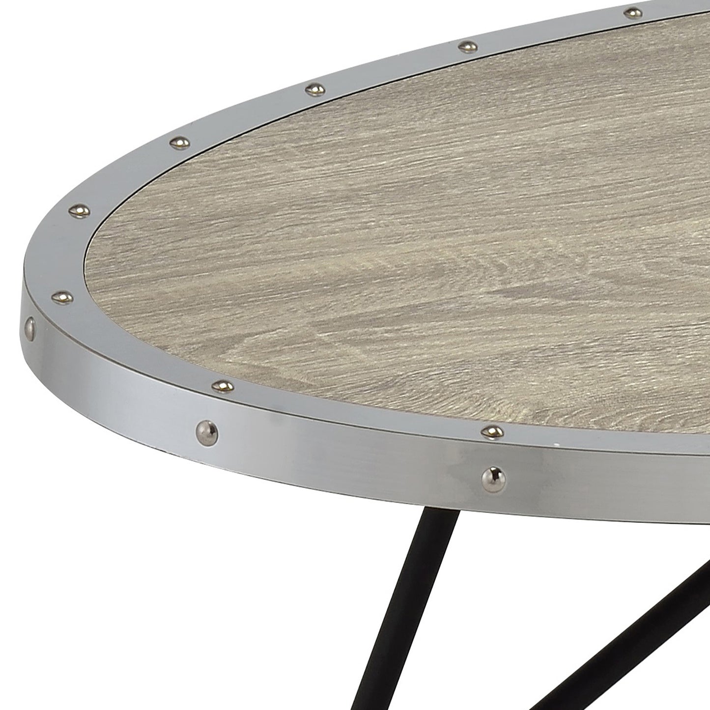Closeup of oval oak wood coffee table top with silver metal trim and rivets