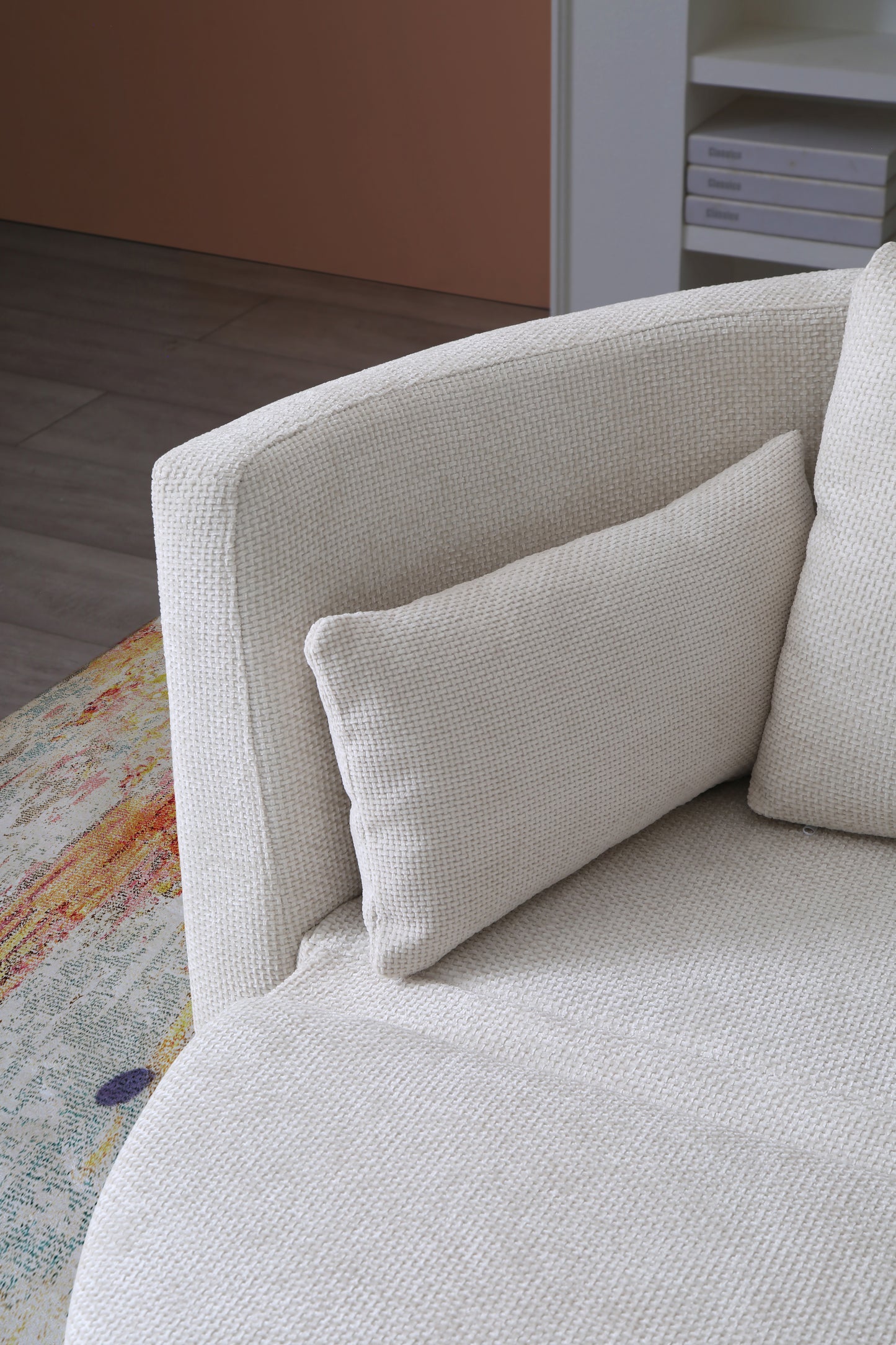 Textured offwhite sofa with matching lumbar pillow ideal for modern living rooms