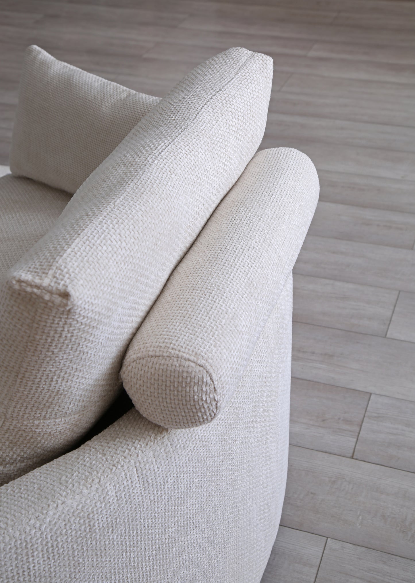 Textured cream sofa with curved armrest and lumbar pillow modern design