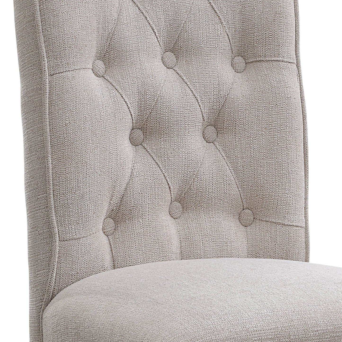 Closeup of a tufted beige fabric dining chair back with button details