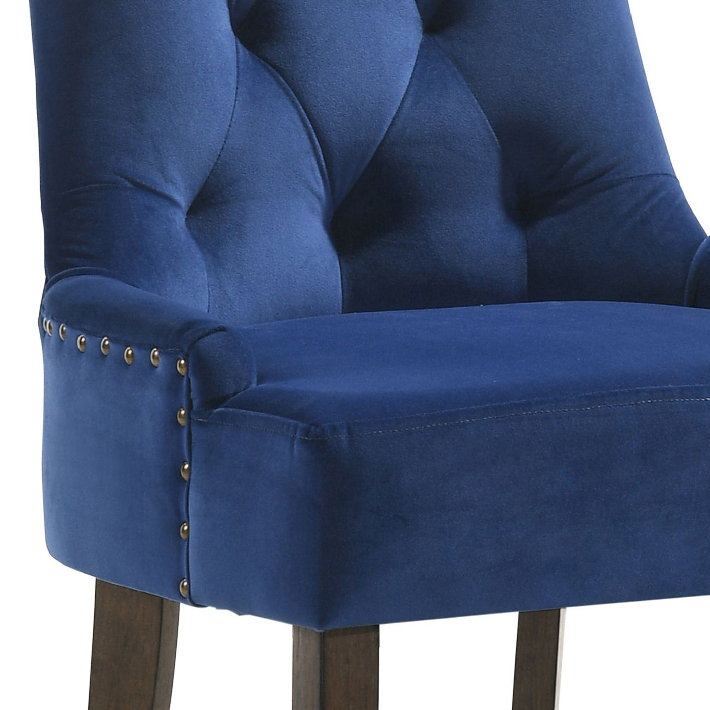 Deep blue velvet armchair with diamond tufting and brass nailhead trim