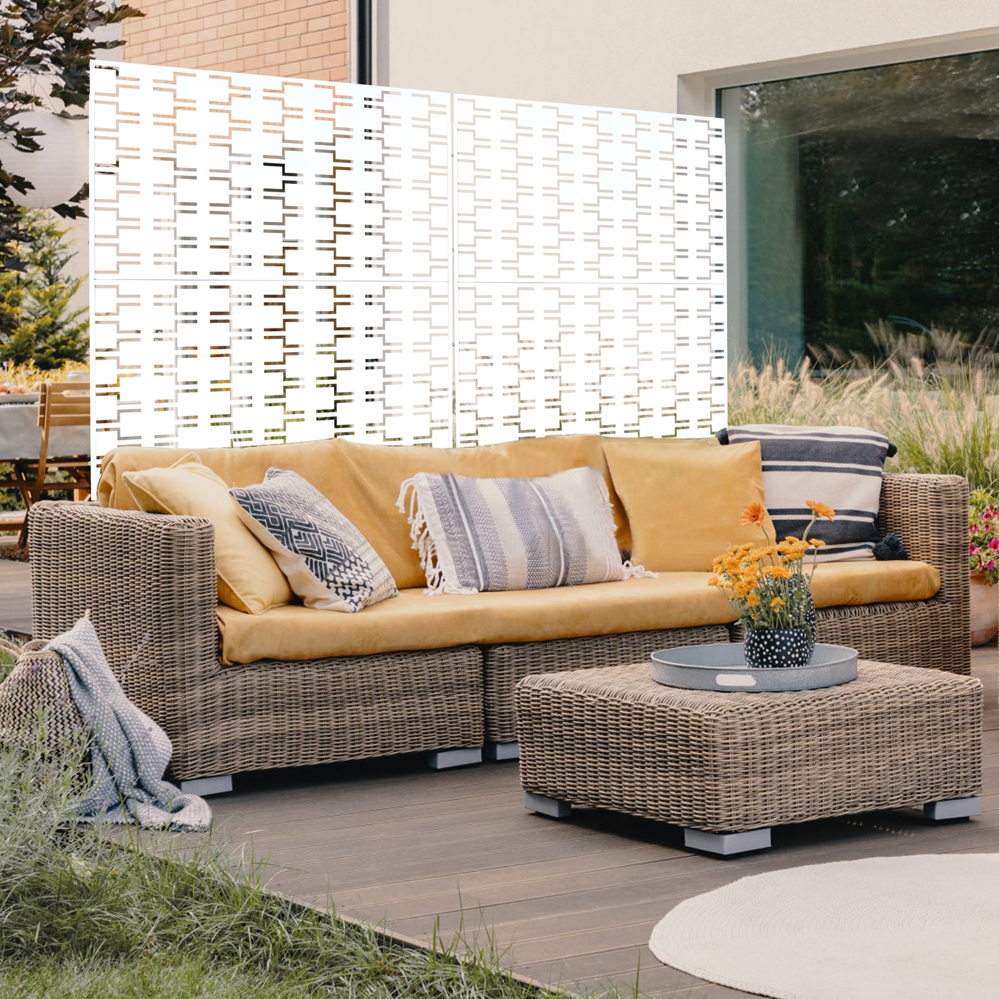 Wicker sectional sofa with mustard cushions and decorative throw pillows on a patio deck