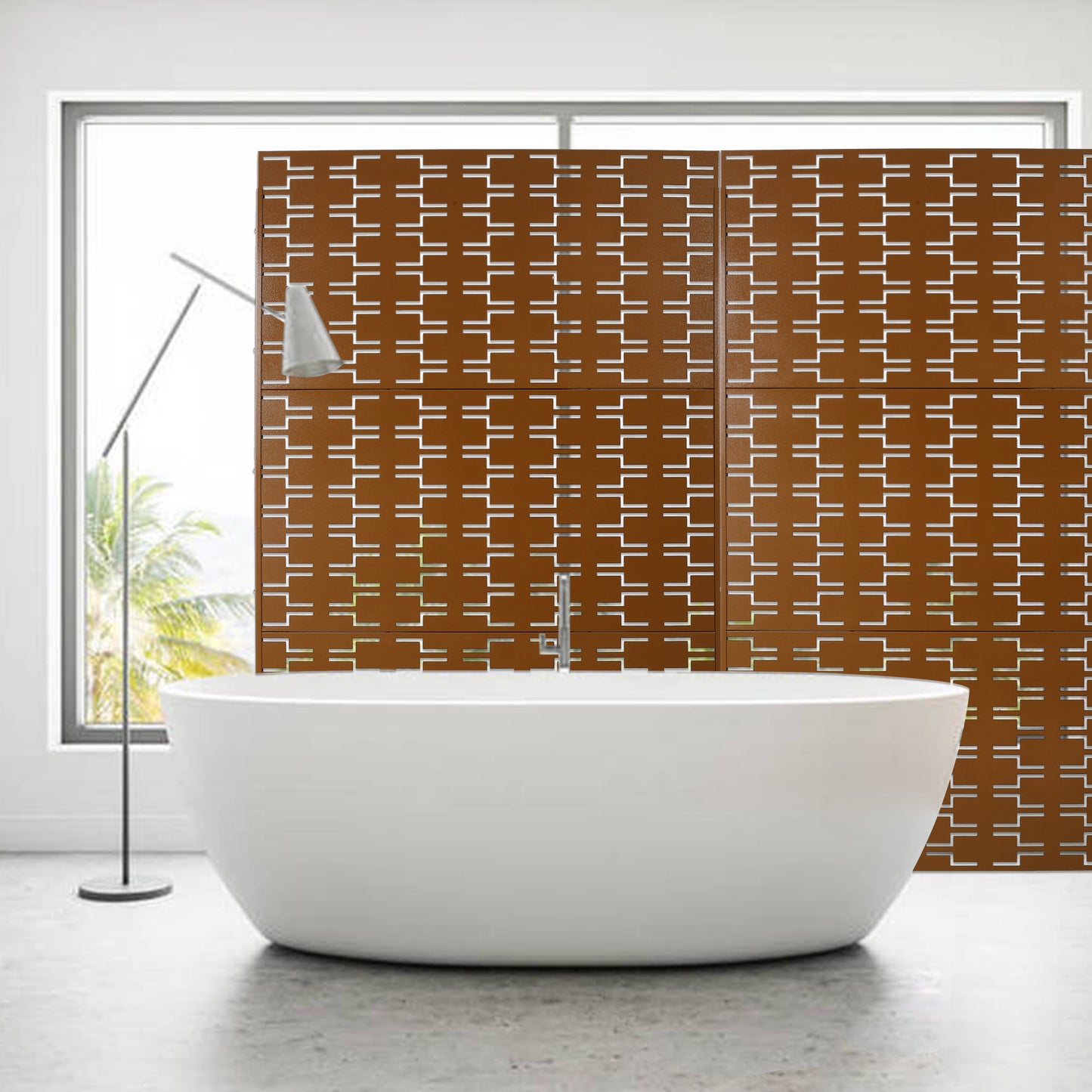 Modern white freestanding bathtub next to a copper geometric patterned screen divider