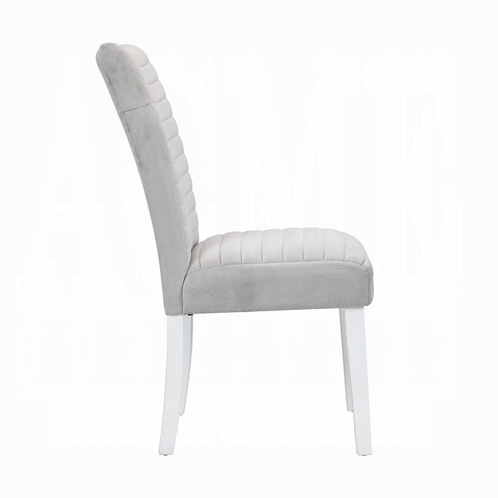 Side view of a modern gray tufted upholstered dining chair with white wooden legs
