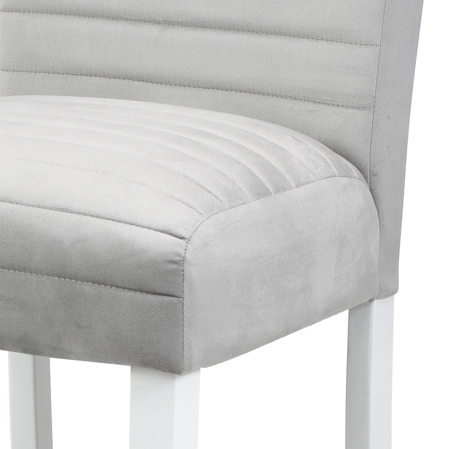 Close up of a light grey upholstered bar stool with subtle channel tufting