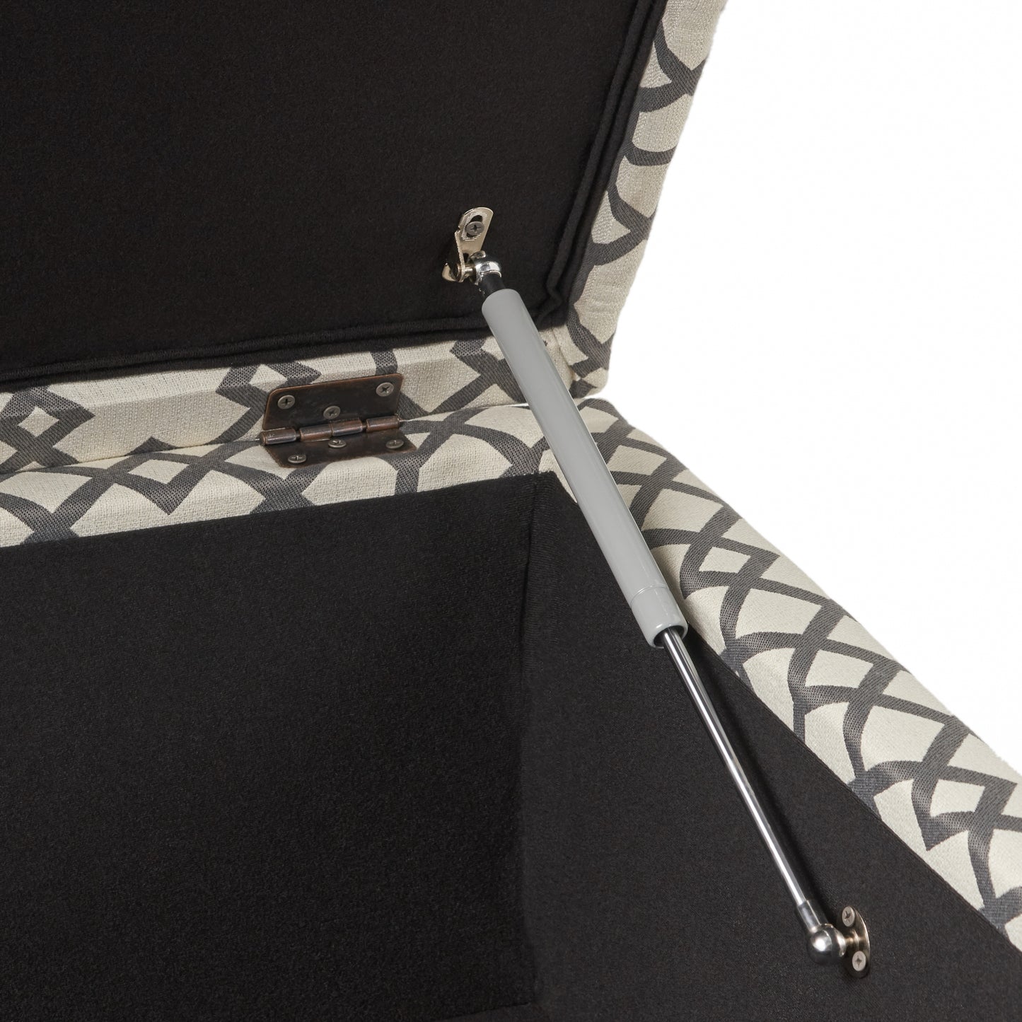 Black upholstered ottoman interior with geometric grey and white pattern on lid