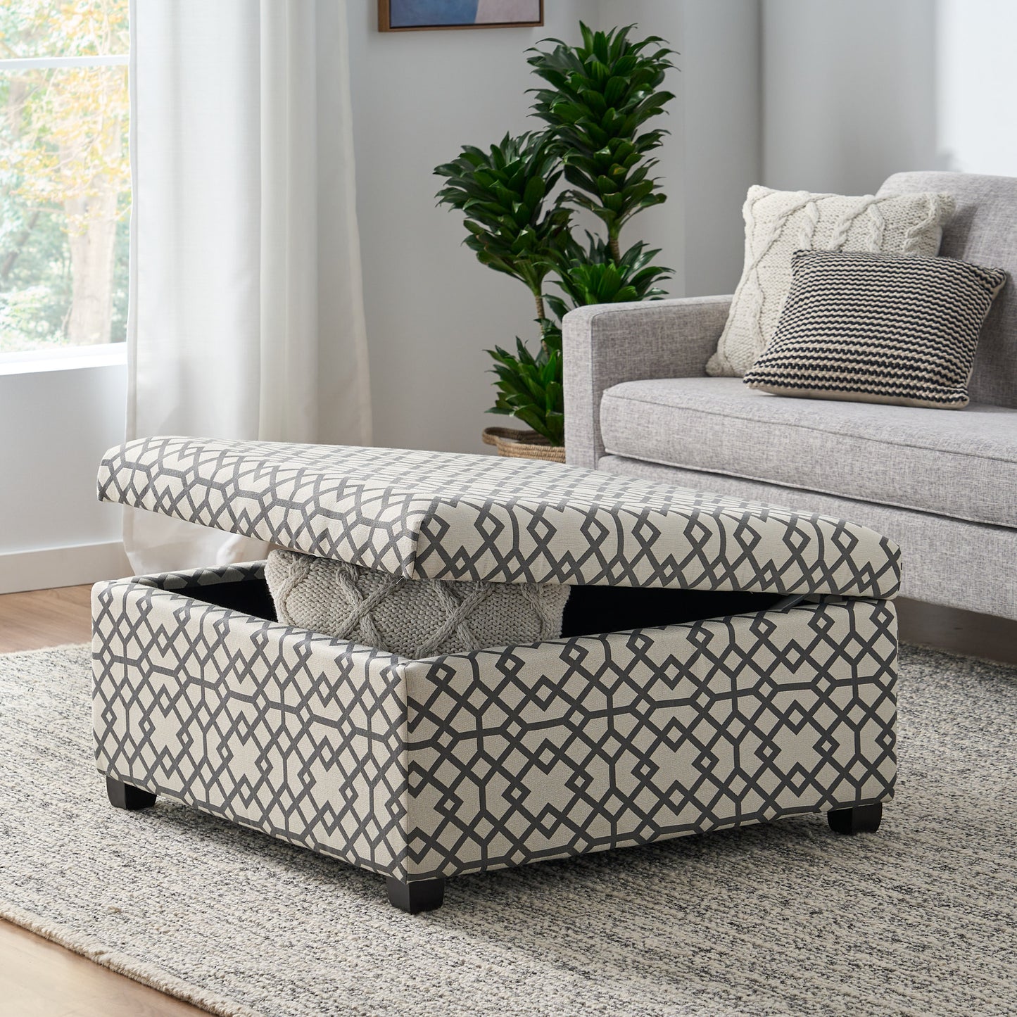 Storage ottoman with beige fabric and grey geometric pattern