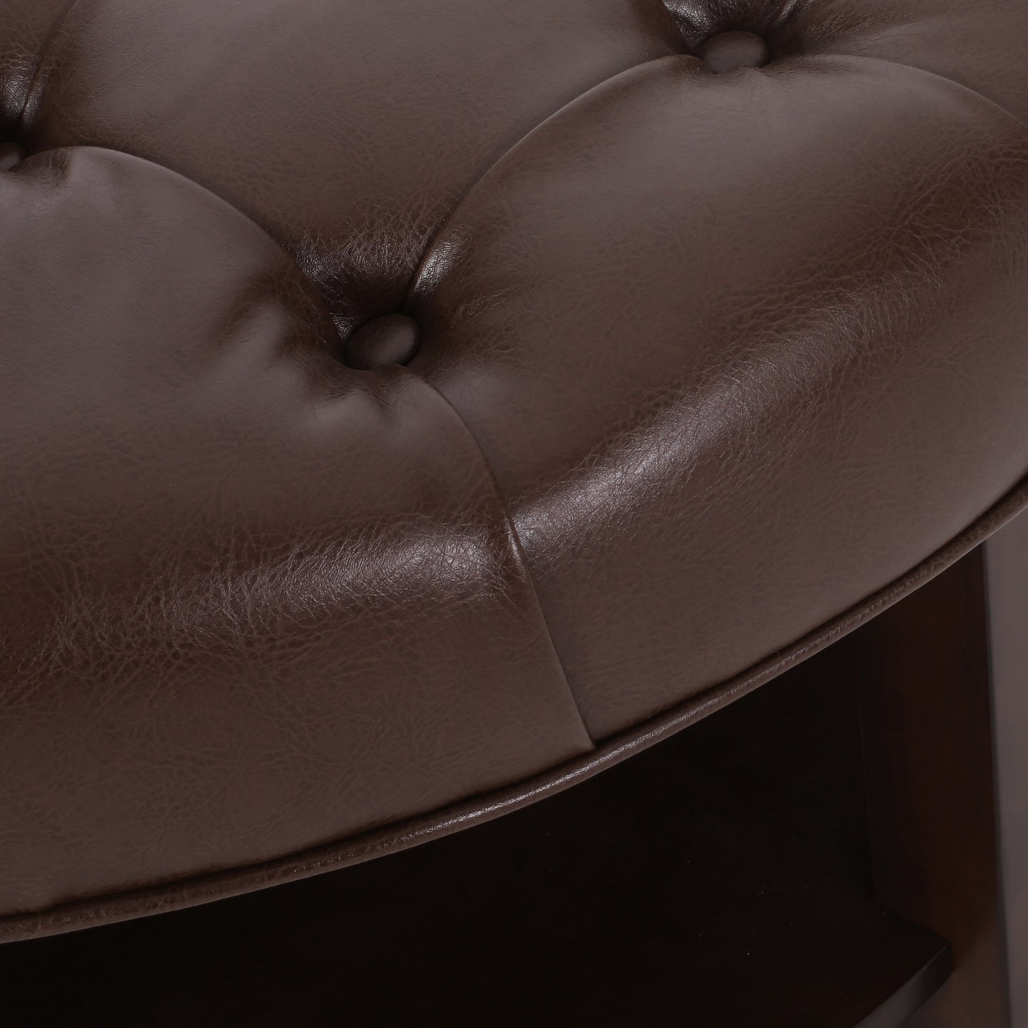 Tufted dark brown faux leather ottoman detail