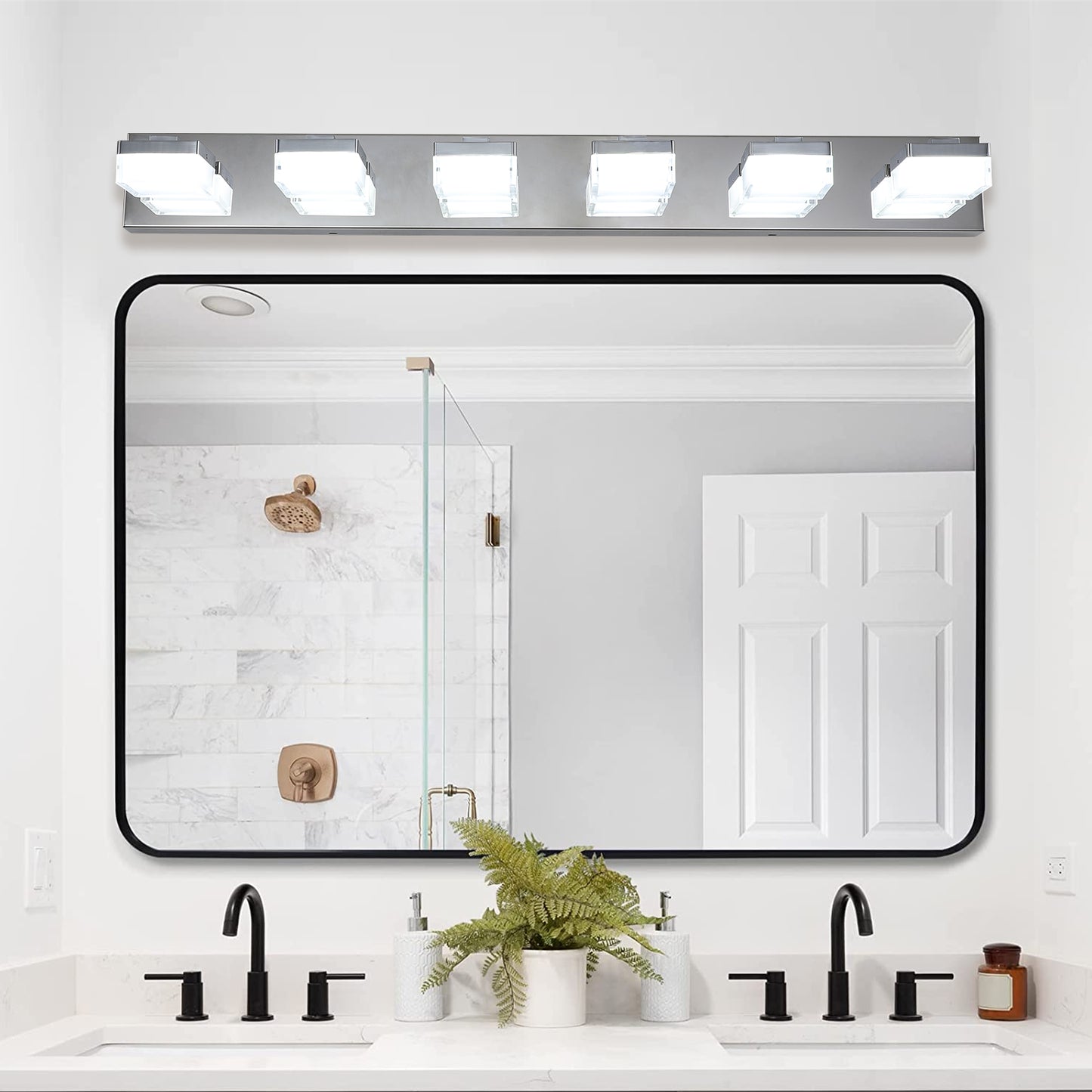 Modern chrome vanity light bar with four frosted glass cube shades illuminates bathroom