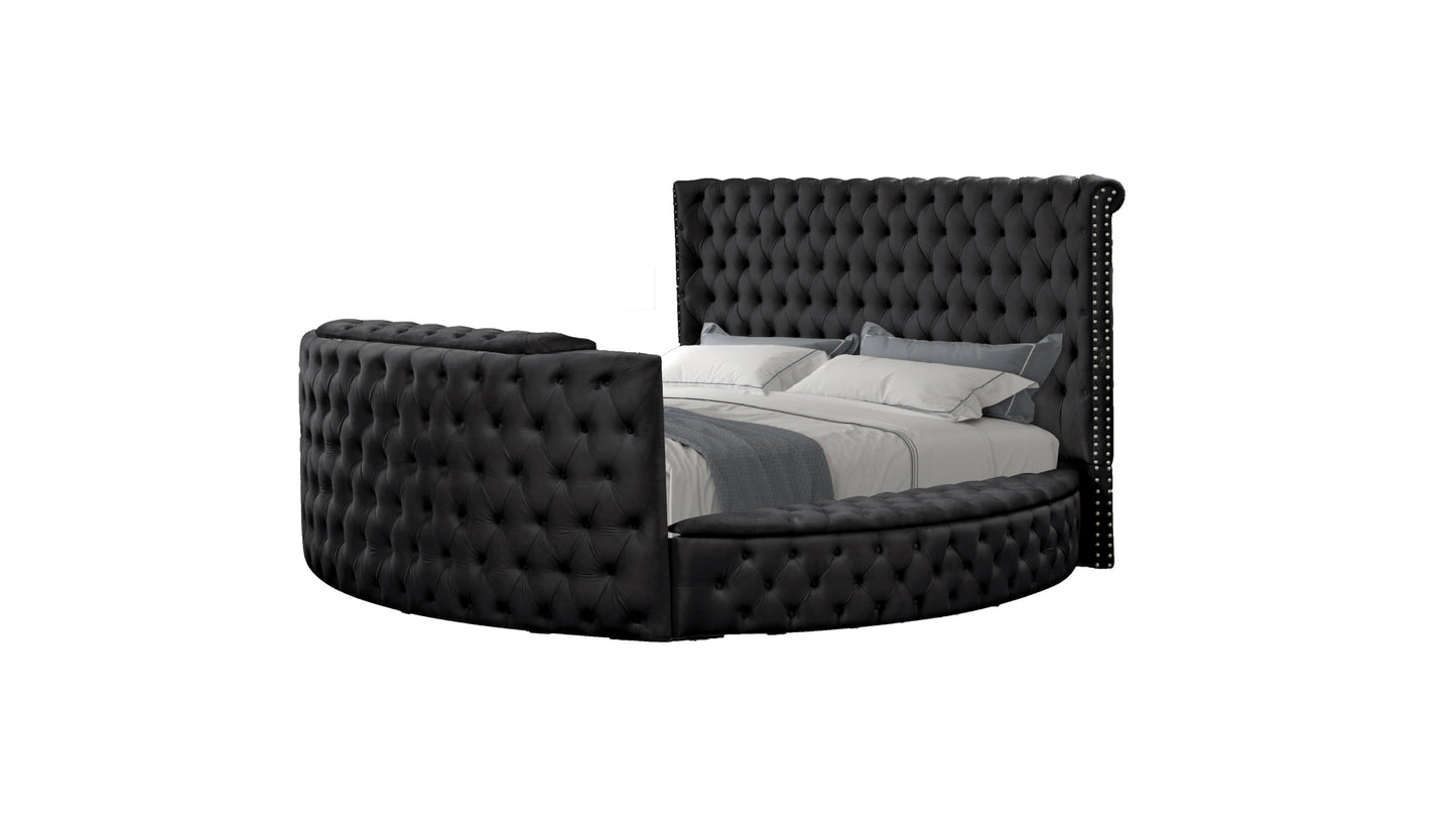 Black tufted velvet round bed with a tall nailheadtrimmed headboard and curved base