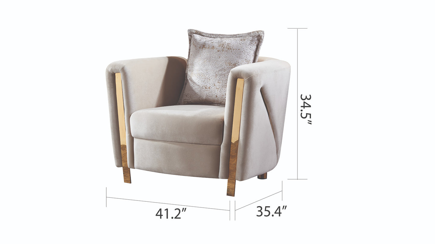 Modern beige velvet armchair with gold accents and decorative pillow