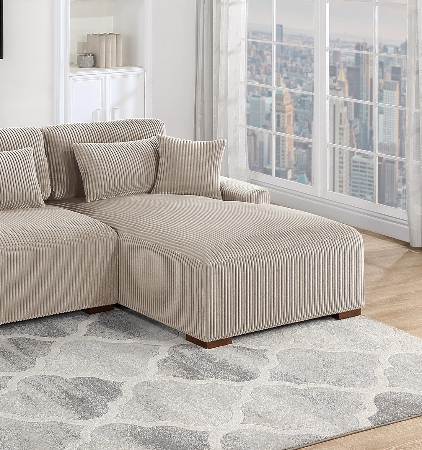 Beige corduroy sectional sofa with plush cushions and a chaise lounge
