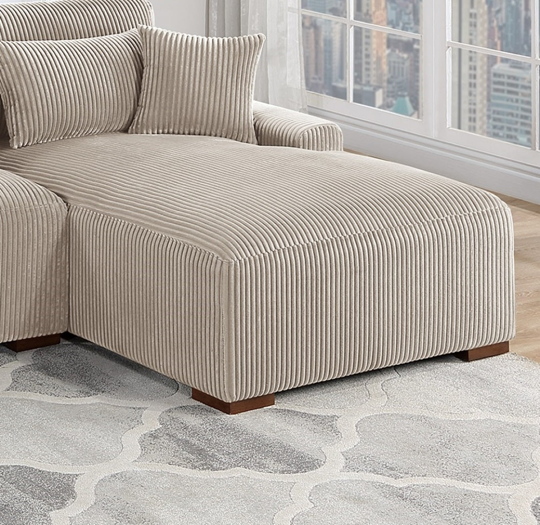 Beige corduroy chaise lounge with plush pillows perfect for modern living rooms