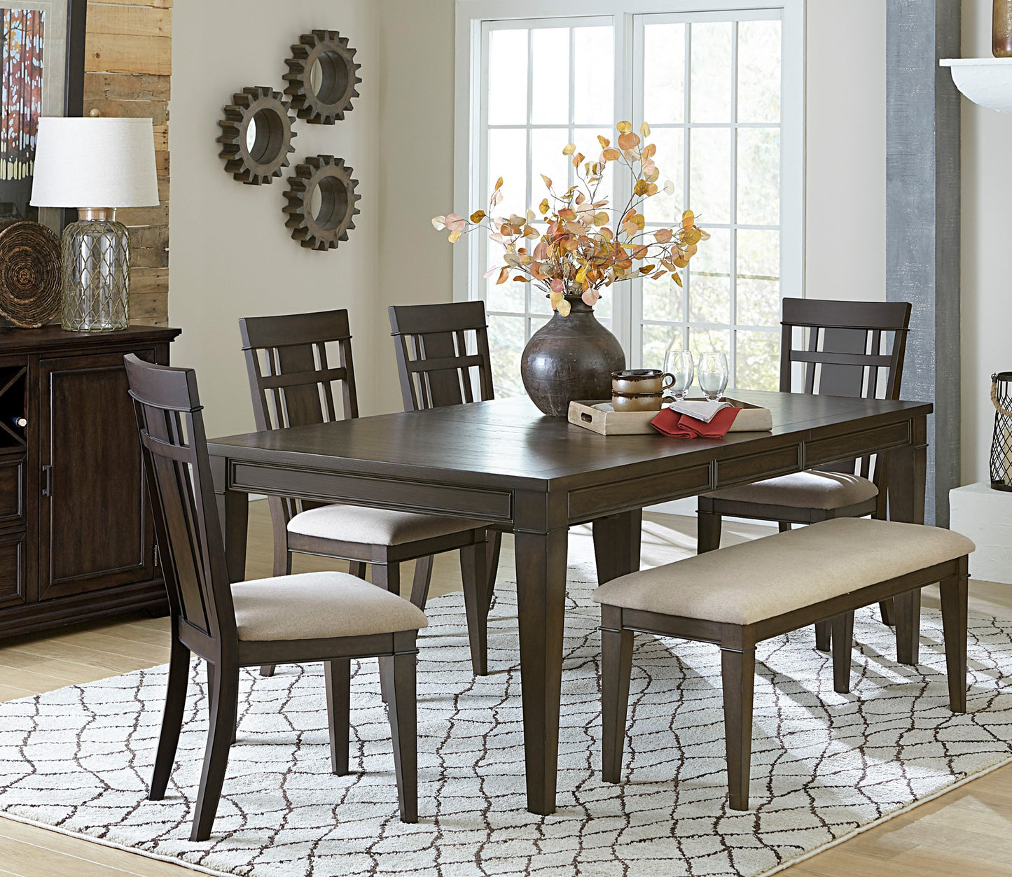 Dark wood dining table with upholstered chairs and bench perfect for family meals