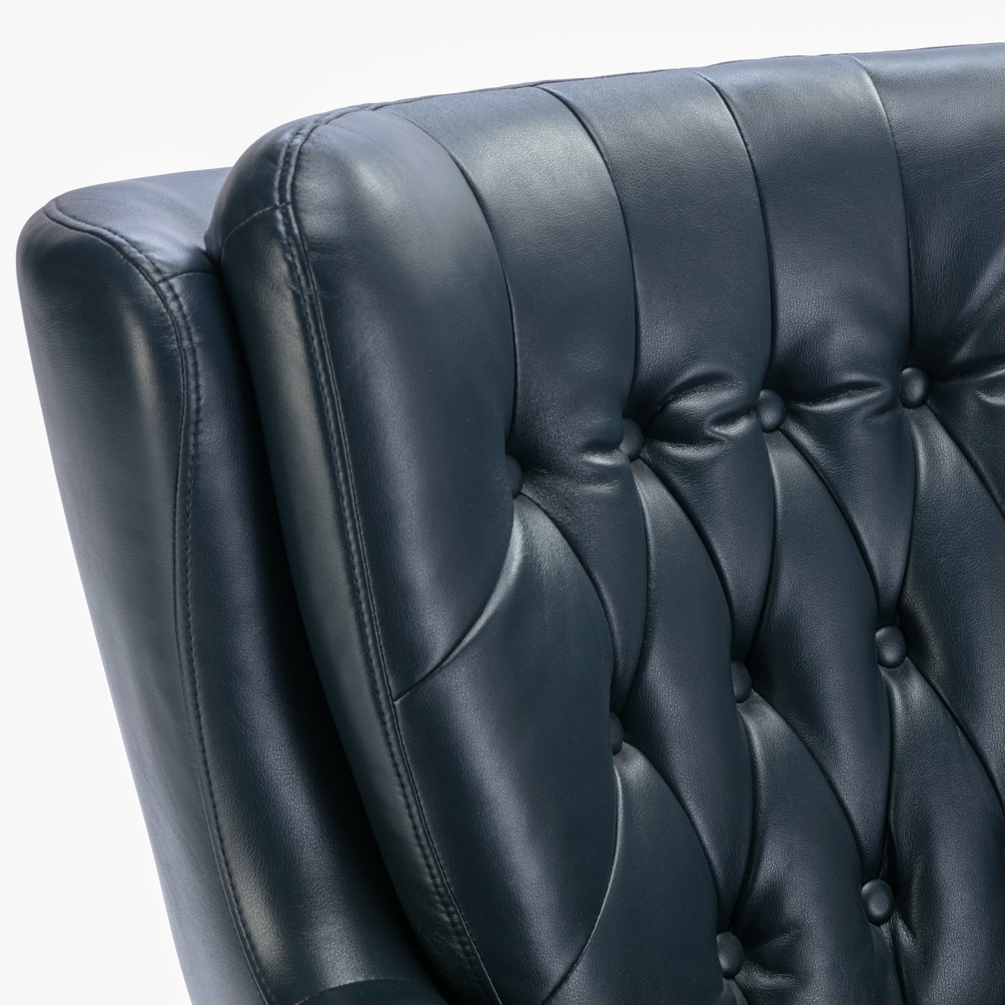 Closeup of tufted dark blue leather armchair back with button details