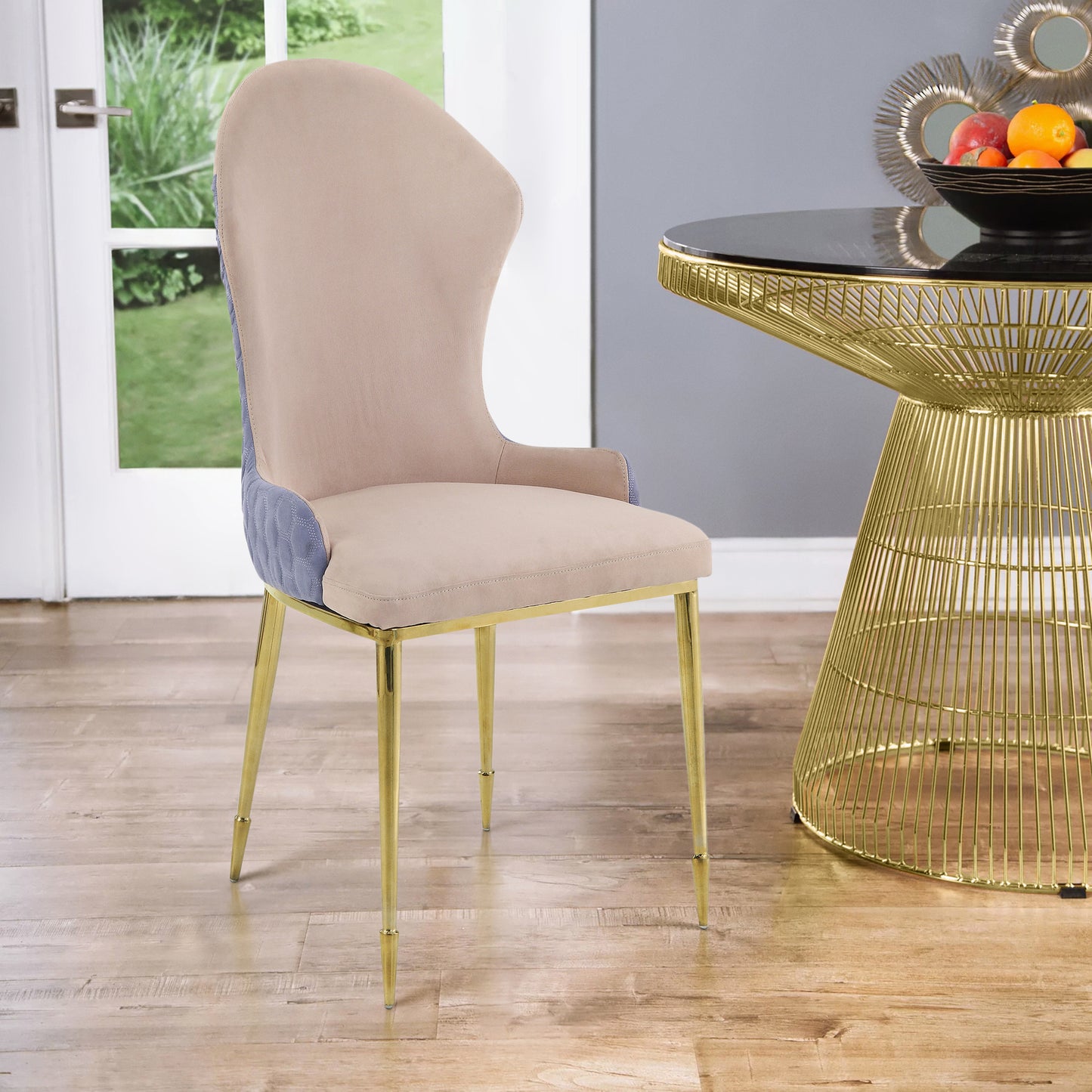 Cream velvet dining chair with blue quilted side panels and gold legs